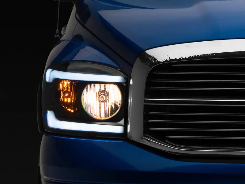 Raxiom 06-09 Dodge Ram 1500/2500/3500 Axial Headlights W/ Seql Led Bar- Blk Housing (Clear Lens) 1